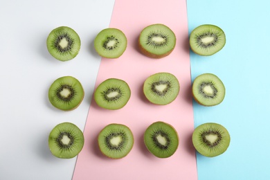 Top view of sliced fresh kiwis on color background