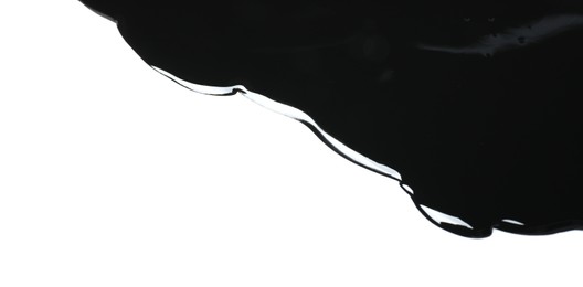 Photo of Black glossy paint spilled on white background