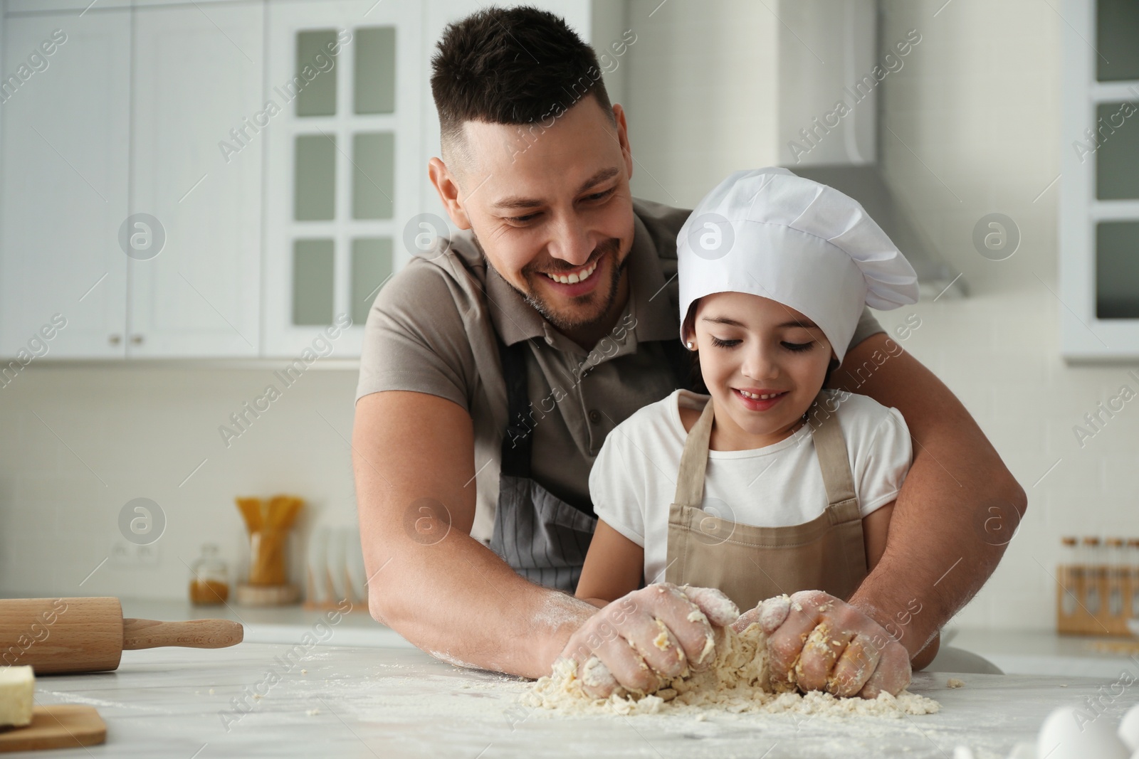 Photo of Father and daughter cooking together in kitchen