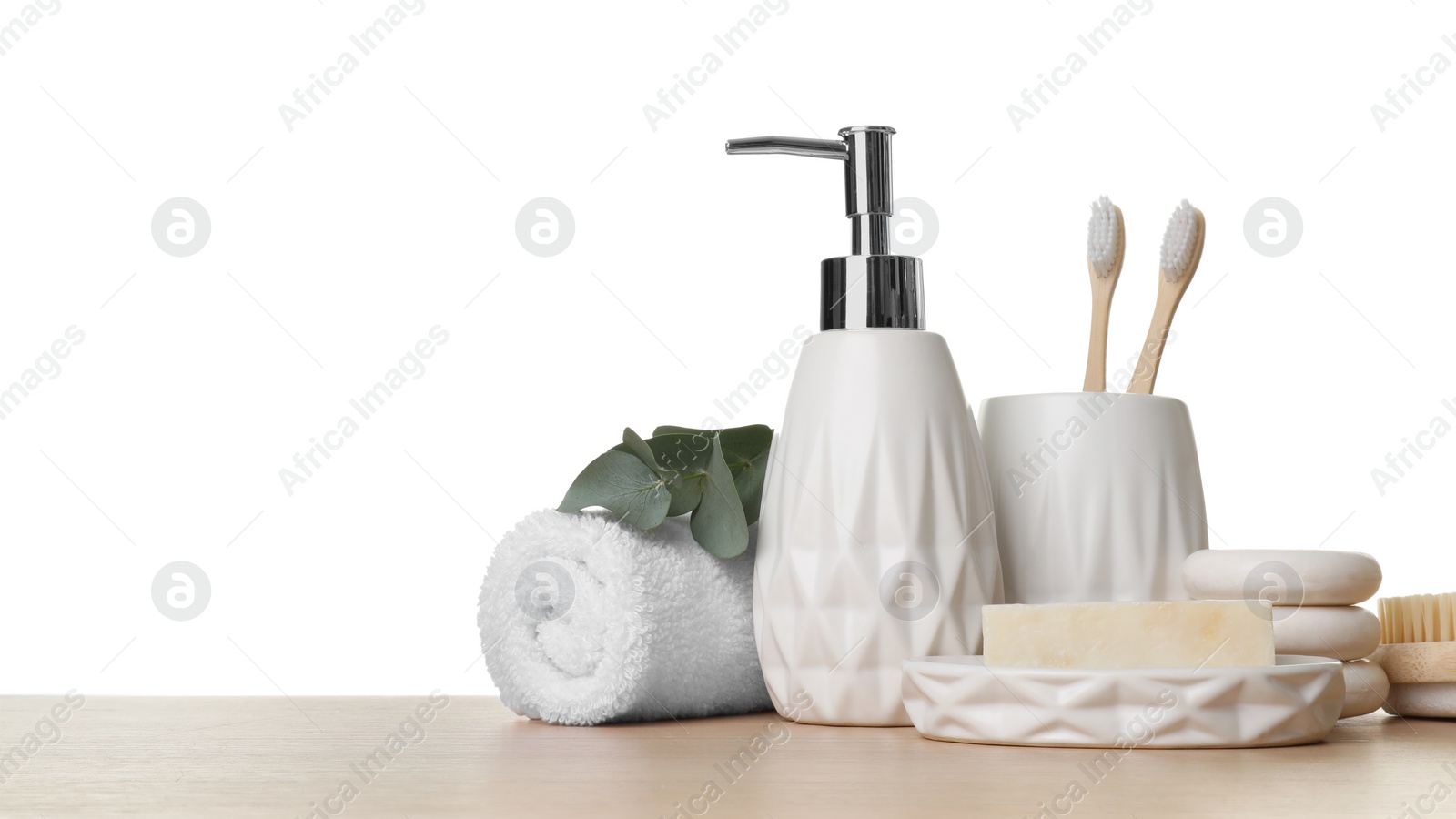 Photo of Bath accessories. Different personal care products and eucalyptus branch on wooden table against white background. Space for text