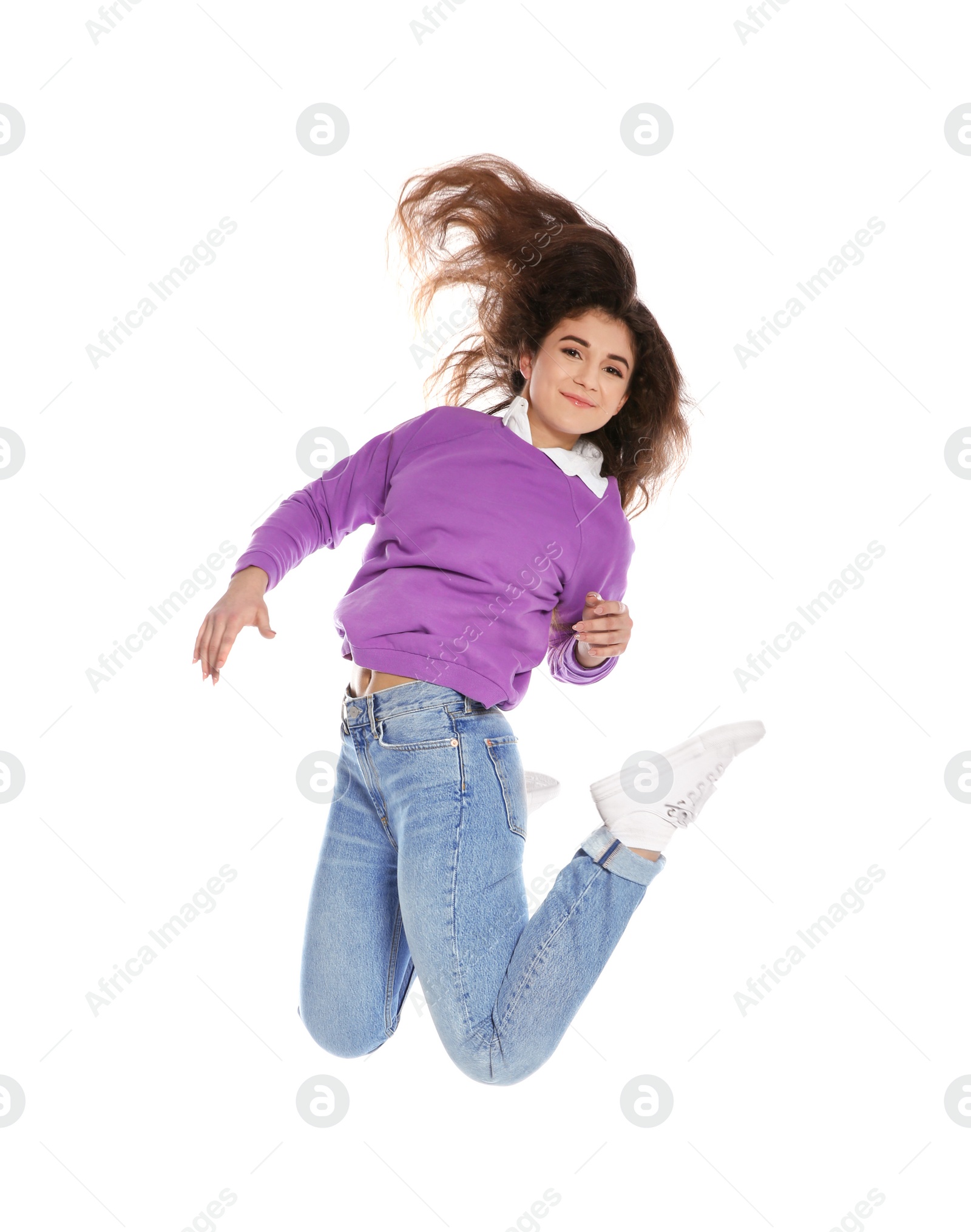 Photo of Beautiful young woman in stylish clothes jumping on white background