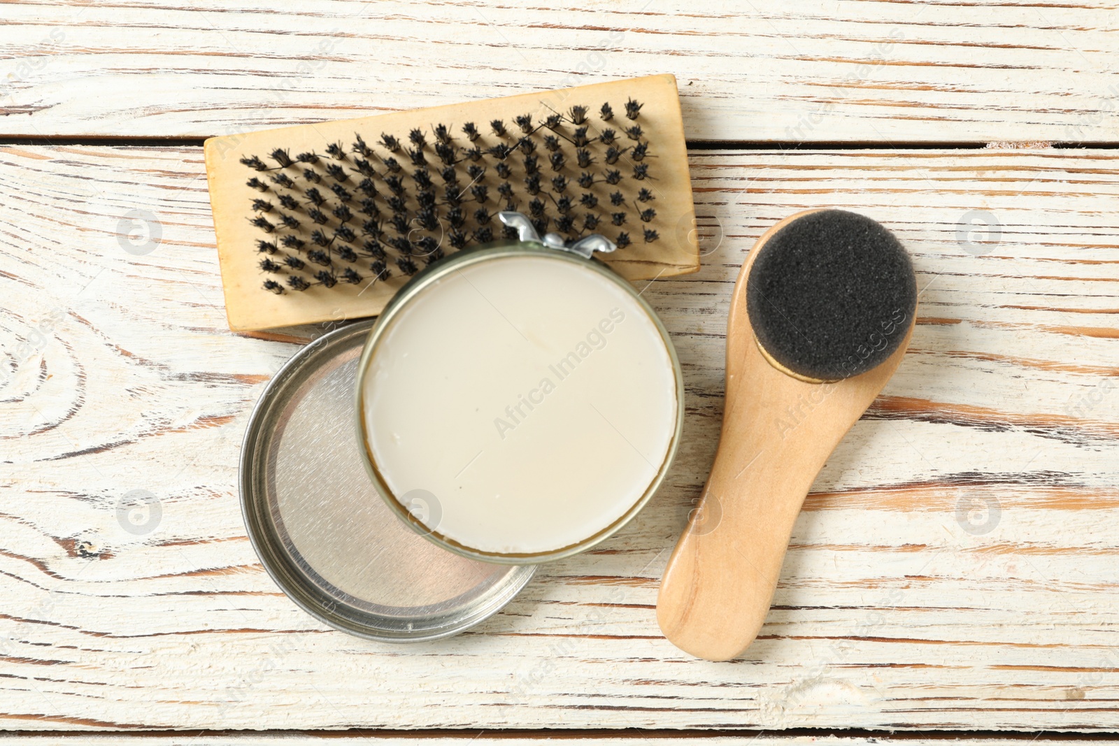 Photo of Shoe care accessories on white wooden background, flat lay