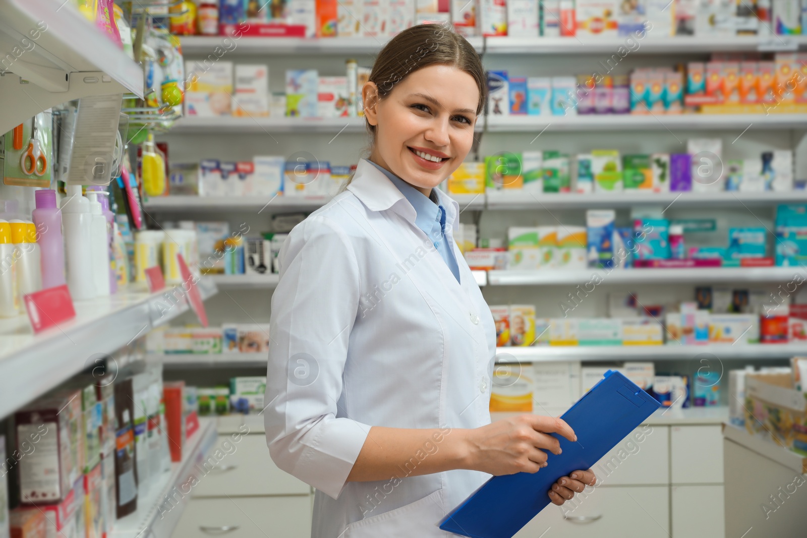 Photo of Professional pharmacist with clipboard in modern drugstore