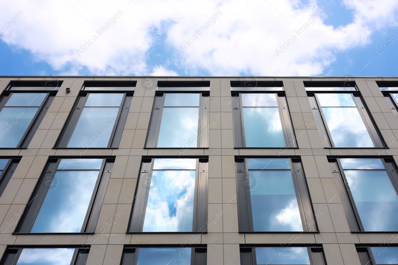 Photo of Modern building against blue sky, low angle view