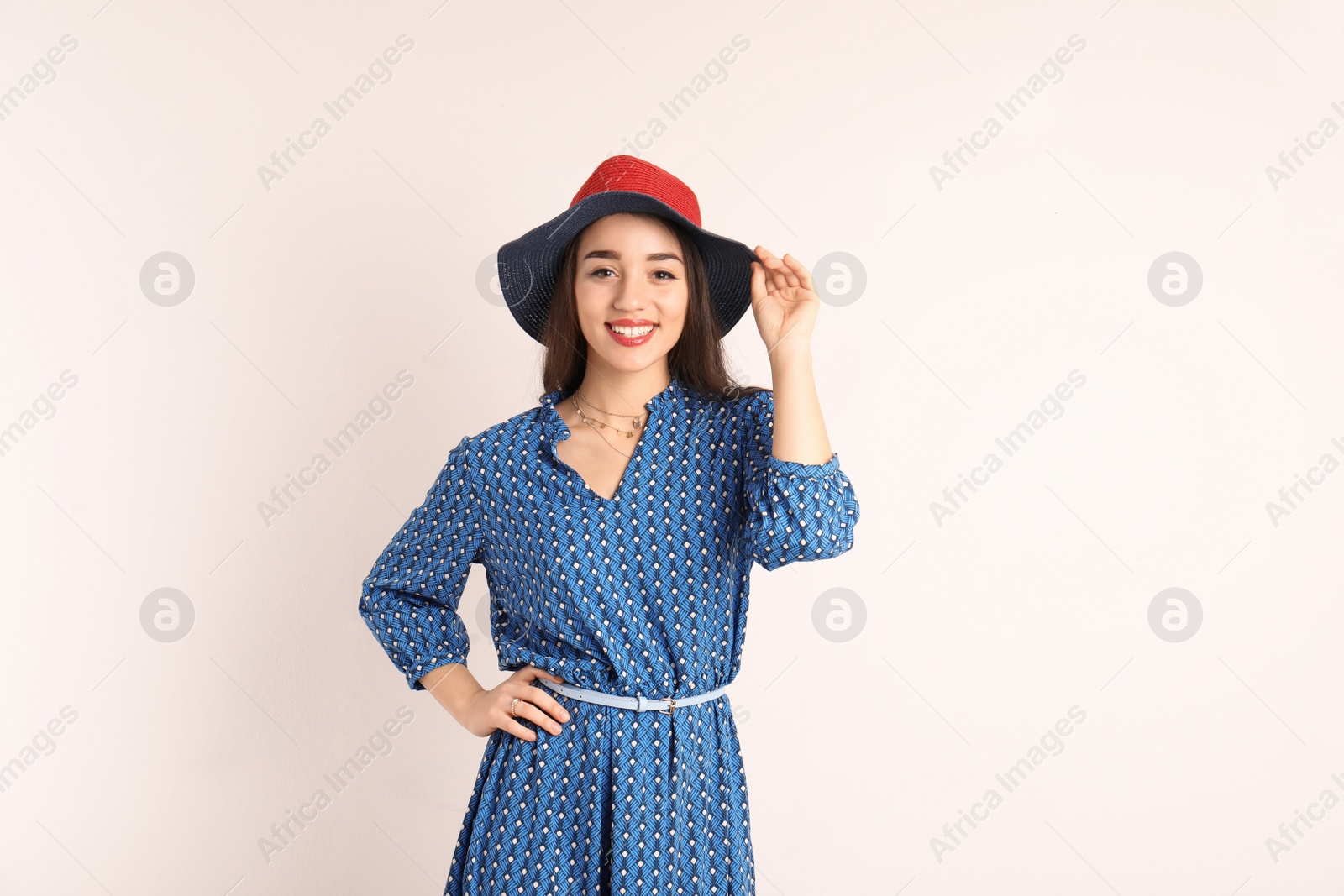 Photo of Portrait of beautiful young woman in stylish dress on white background