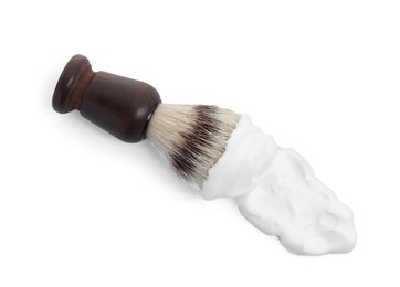 Photo of Shaving brush and foam on white background, top view