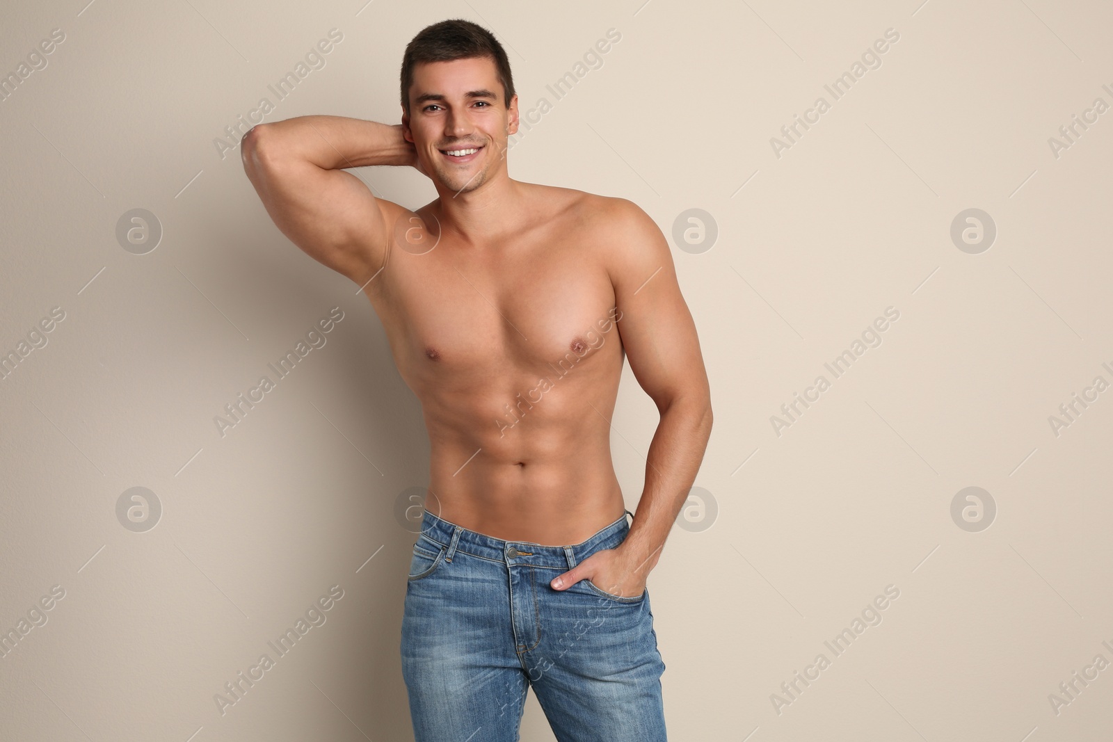 Photo of Man with sexy body on beige background