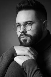 Portrait of handsome bearded man on dark background. Black and white effect