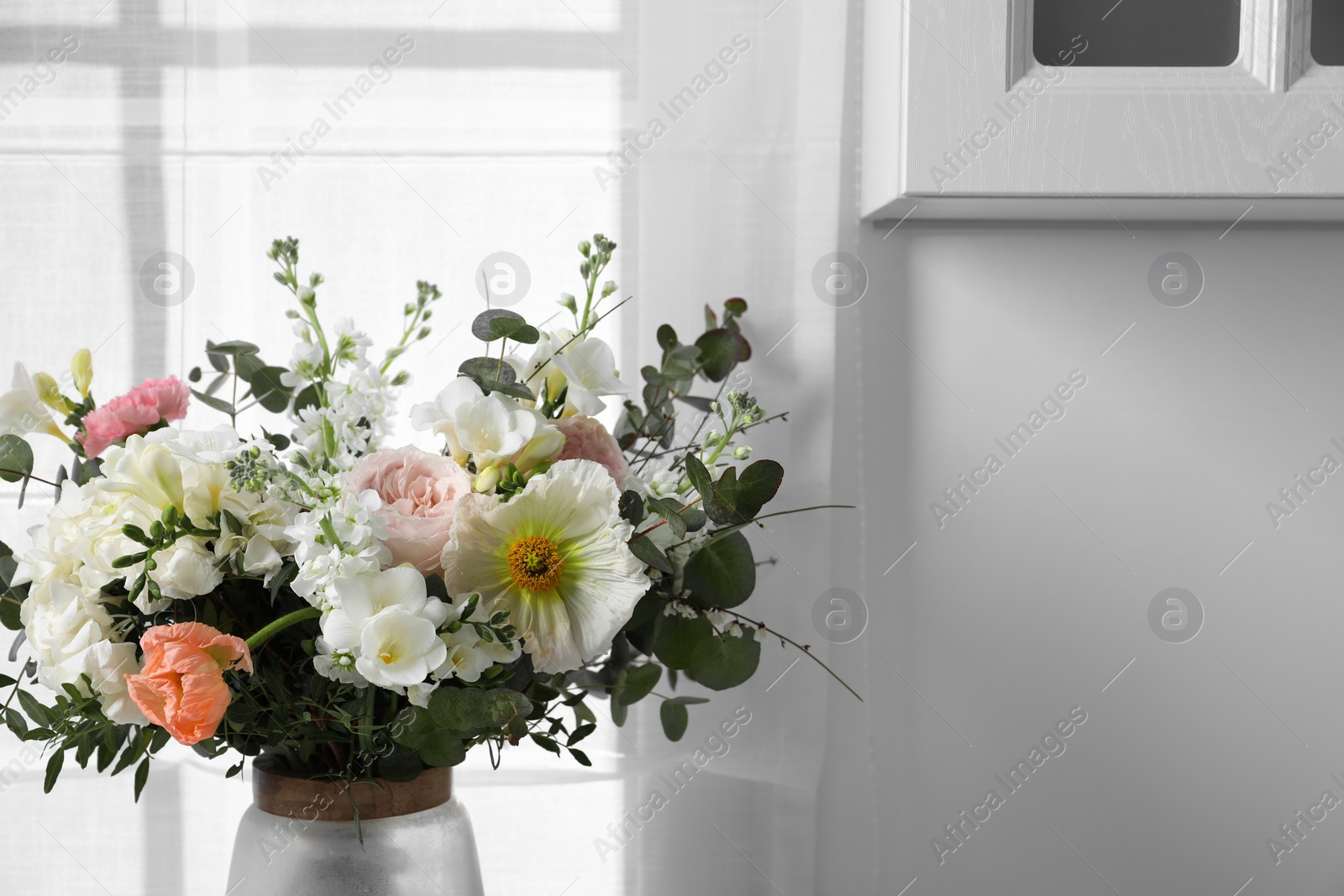 Photo of Beautiful bouquet of different fresh flowers indoors, closeup. Space for text