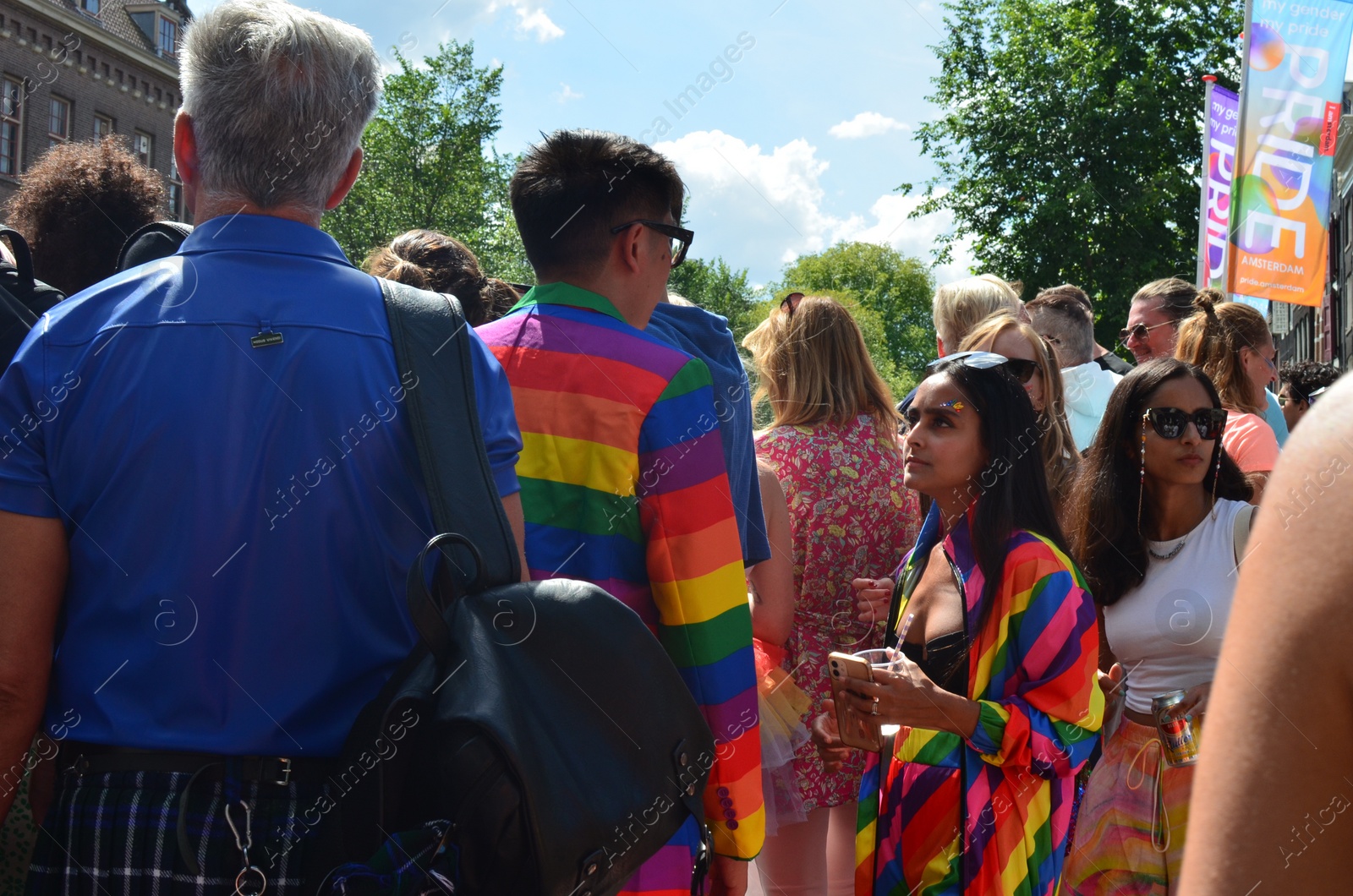 Photo of AMSTERDAM, NETHERLANDS - AUGUST 06, 2022: Many people at LGBT pride parade on sunny day