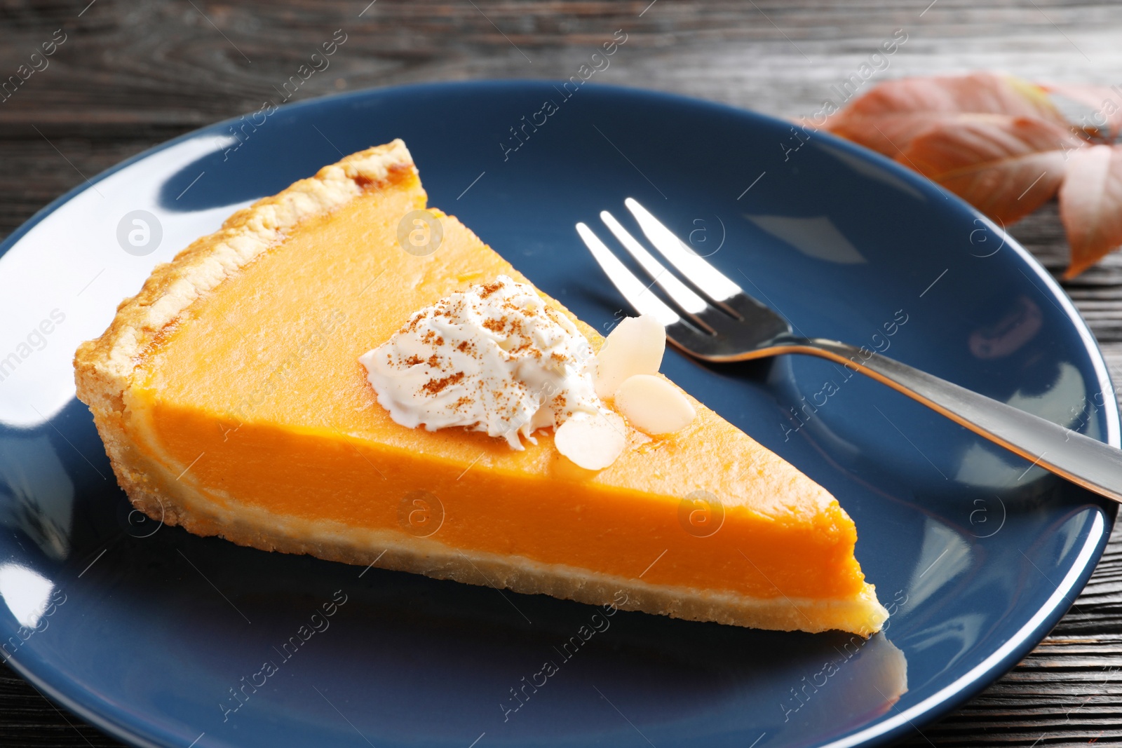 Photo of Plate with piece of fresh delicious homemade pumpkin pie on table