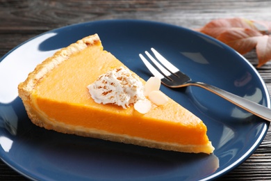 Photo of Plate with piece of fresh delicious homemade pumpkin pie on table