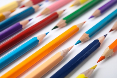 Composition with color pencils on white background, closeup