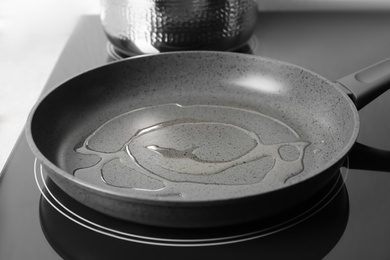 Frying pan with cooking oil on induction stove