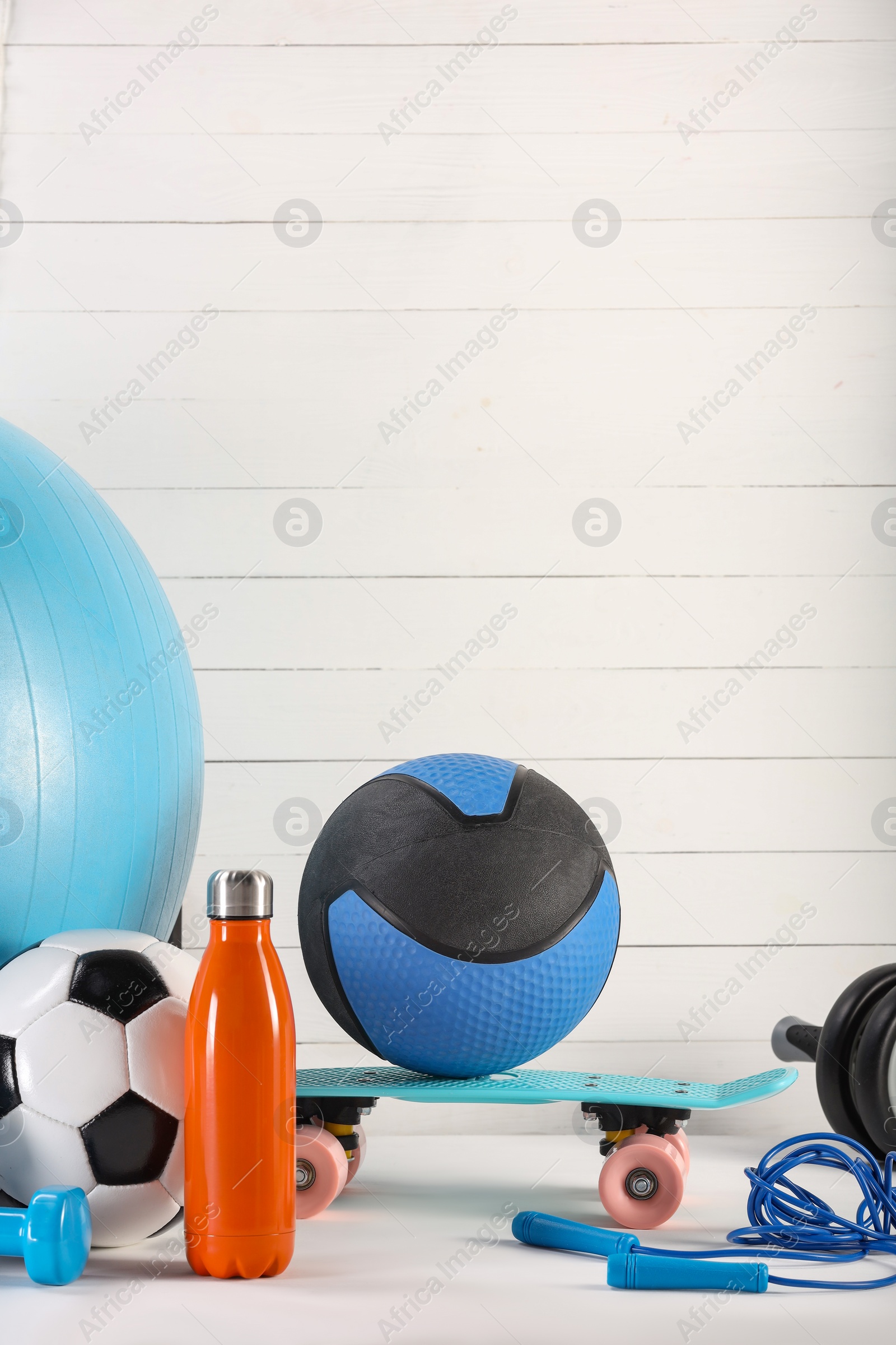 Photo of Many different sports equipment on white table