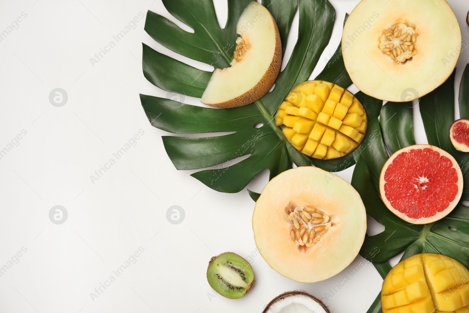 Photo of Flat lay composition with melon, other fruits and space for text on white background