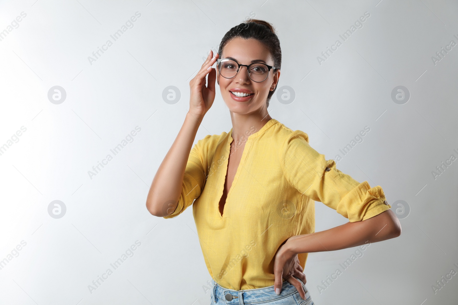 Photo of Beautiful woman in eyeglasses on white background