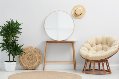 Photo of Stylish round mirror near white wall in room