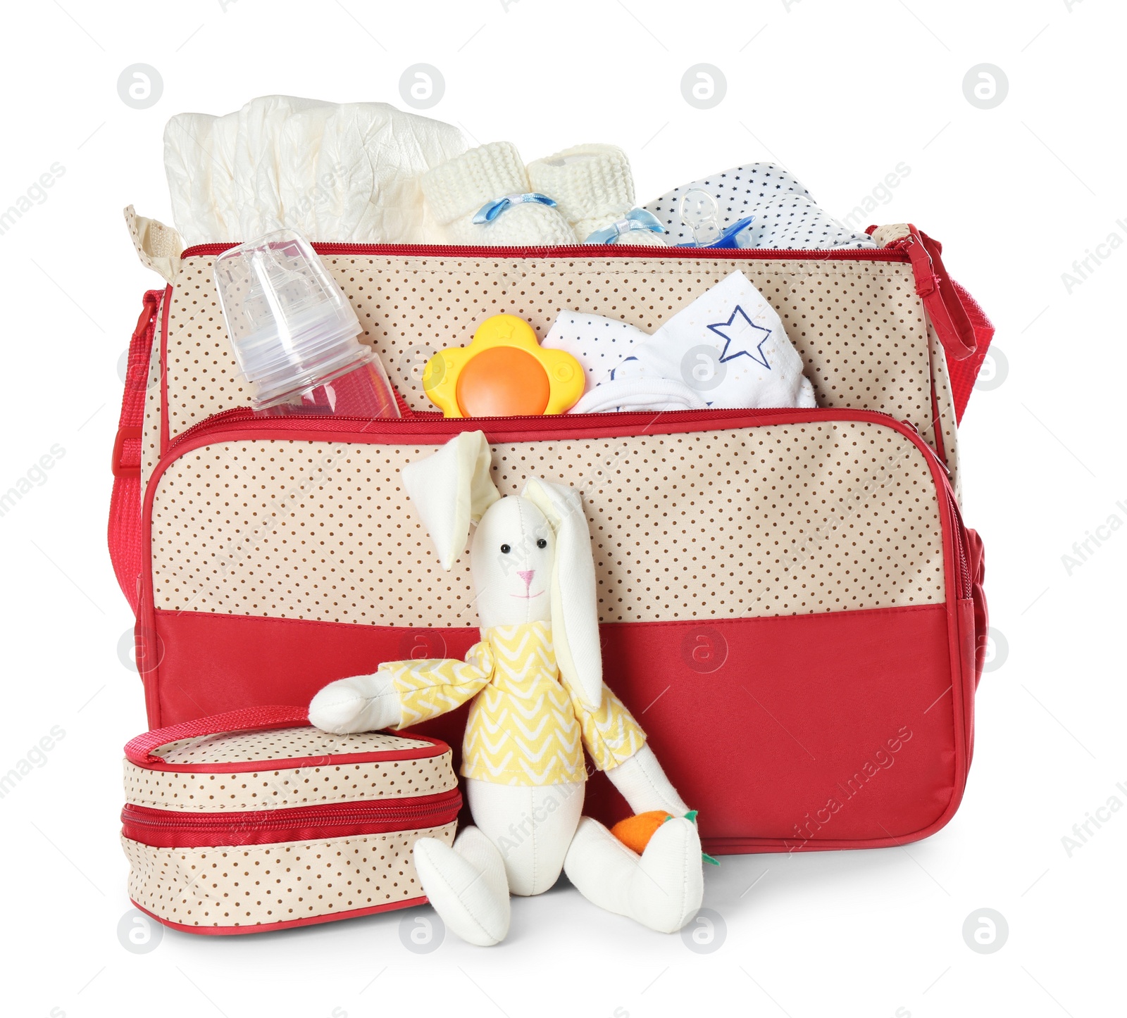 Photo of Maternity bag with child's clothes and accessories on white background