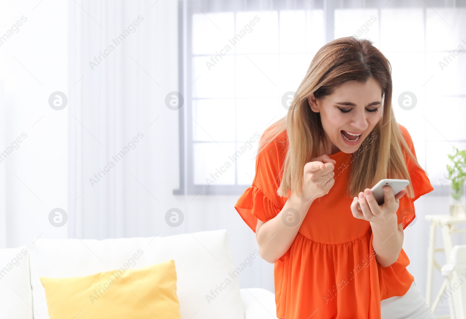 Photo of Woman arguing on mobile phone at home