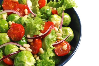 Bowl of salad with Brussels sprouts on white background, closeup