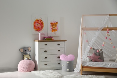 Photo of Cute pictures and and stylish furniture in baby room interior