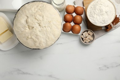 Flat lay composition with fresh dough and different ingredients on white marble table, space for text. Cooking yeast cake