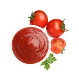 Photo of Tasty ketchup in bowl, parsley and fresh tomatoes isolated on white, top view