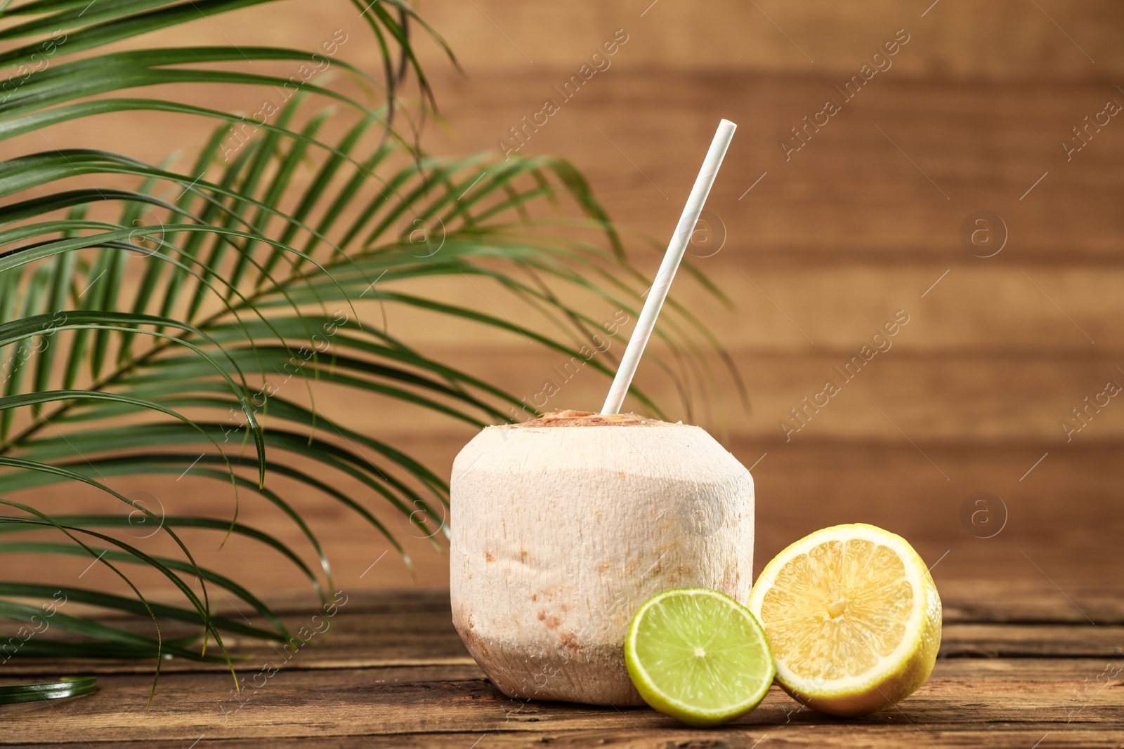 Photo of Open fresh coconut and citrus fruits on wooden table