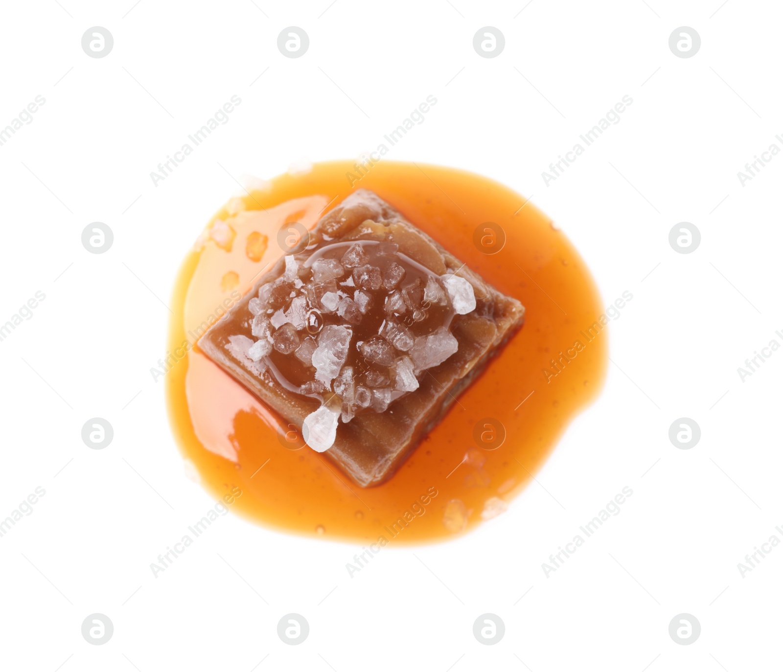 Photo of Delicious salted caramel with sauce on white background, top view