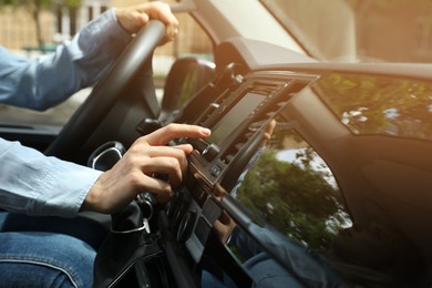 Photo of Woman using navigation system while driving car, closeup