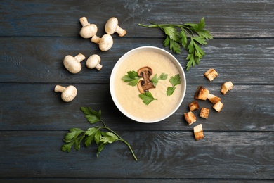 Photo of Flat lay composition with bowl of fresh homemade mushroom soup on wooden background