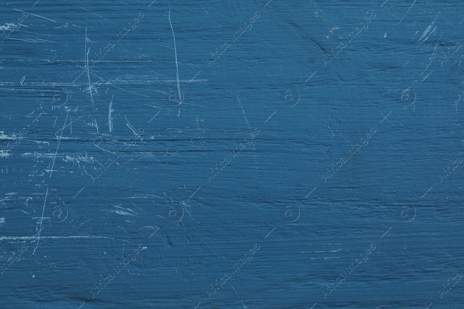 Photo of Old blue wooden surface with scratches as background, closeup