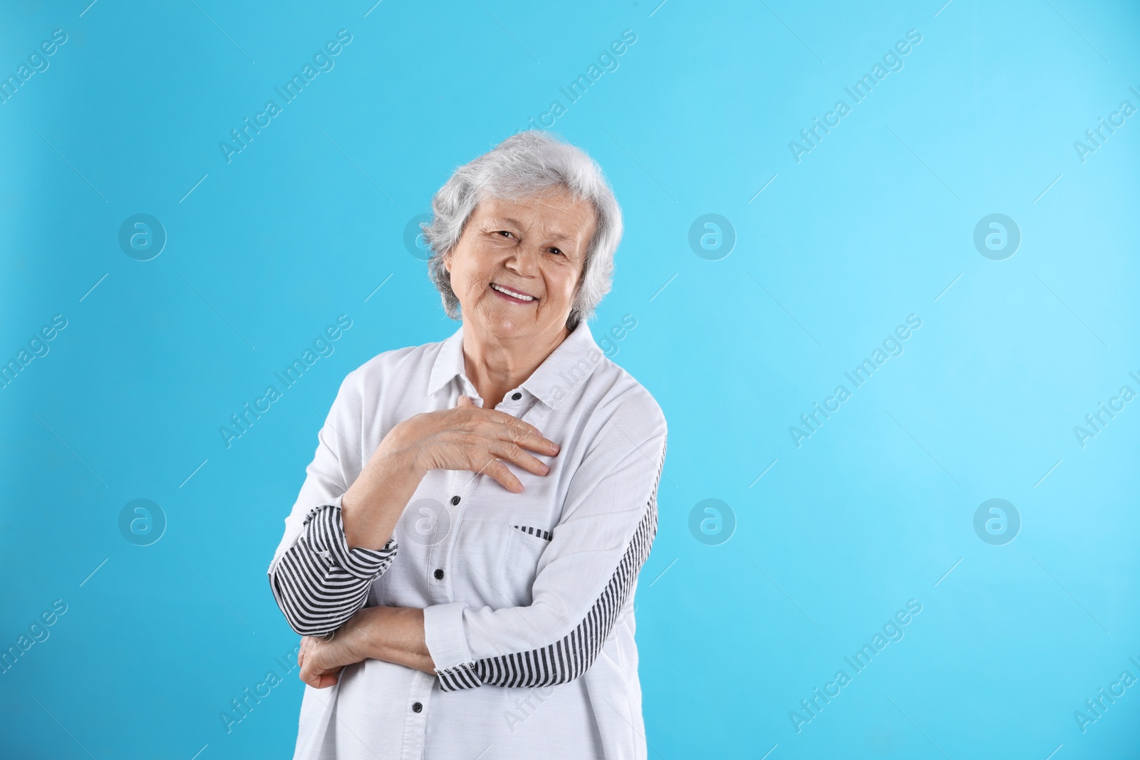 Photo of Portrait of grandmother in stylish clothes on color background, space for text