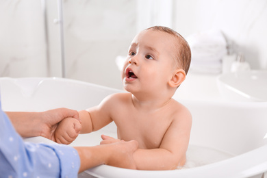 Photo of Mother with her little baby in bathroom