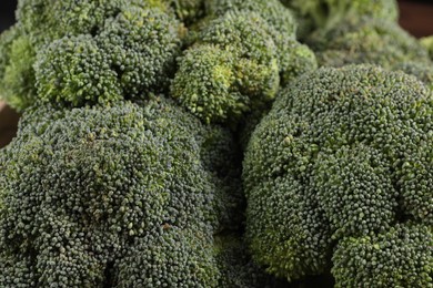 Photo of Fresh raw green broccoli on blurred background, closeup