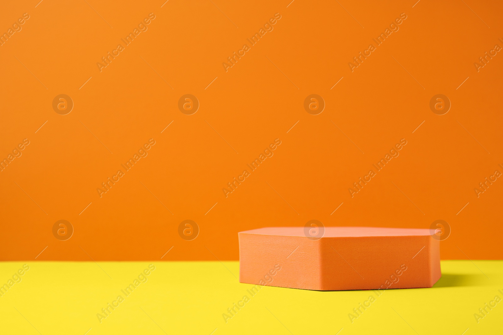 Photo of Hexagon on orange background, space for text. Stylish presentation for product