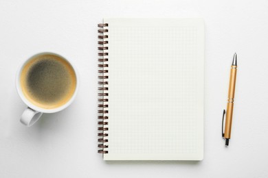 Photo of Notebook, coffee and pen on white table, flat lay. Space for text