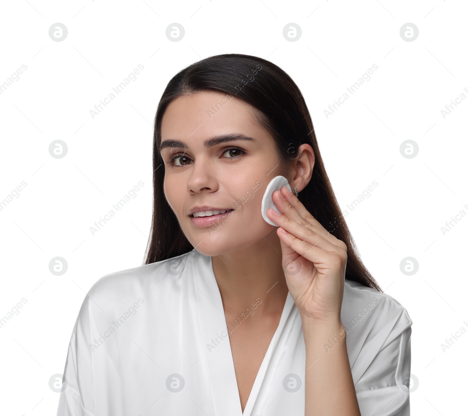 Photo of Young woman cleaning her face with cotton pad on white background