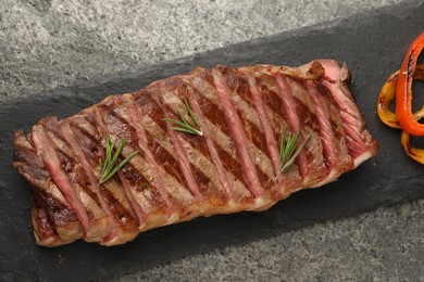 Delicious grilled beef steak with spices on gray table, top view
