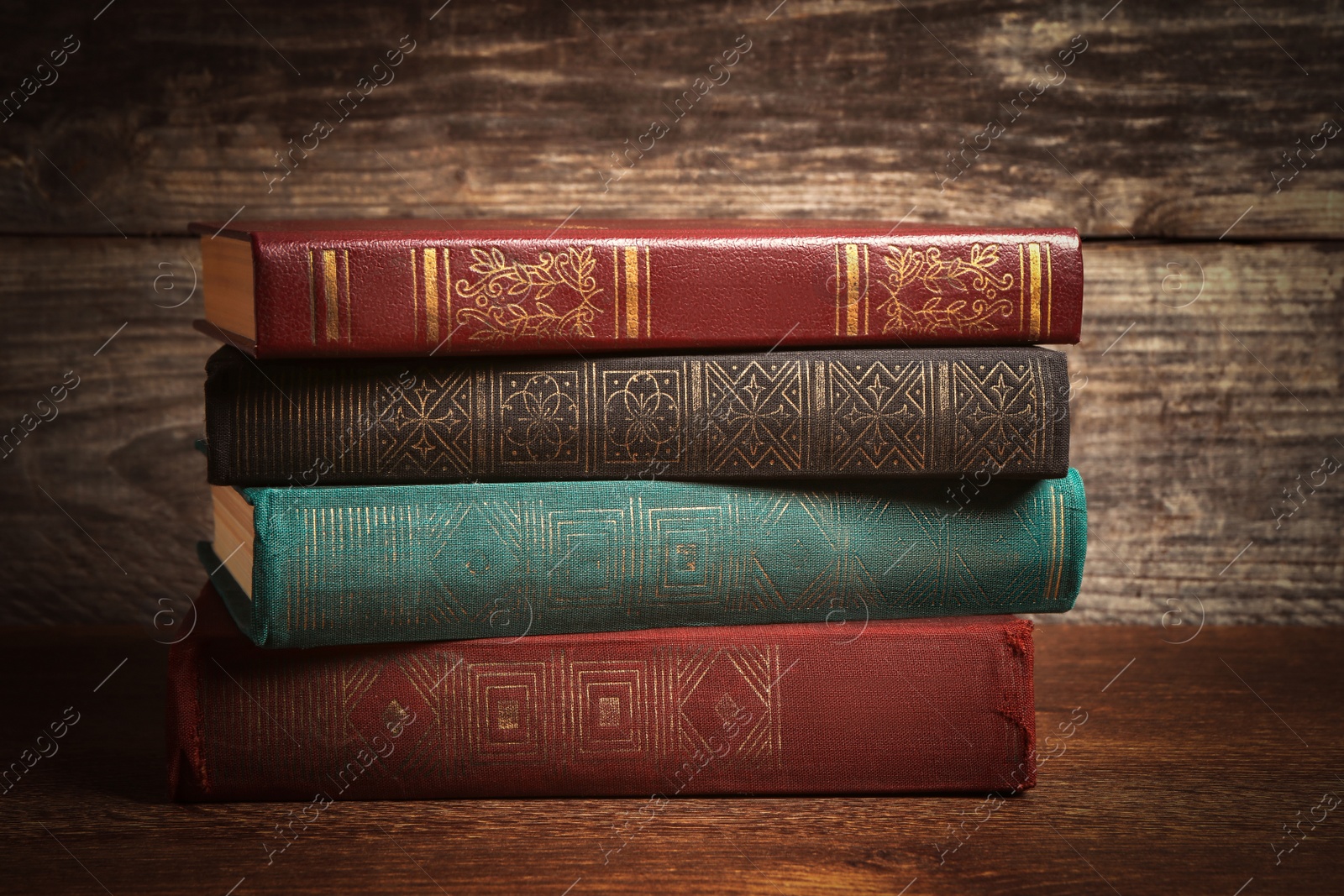 Image of Stack of old hardcover books on wooden table