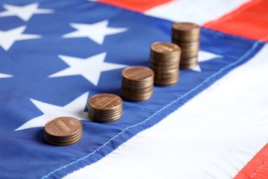 Different stacks of coins on national USA flag