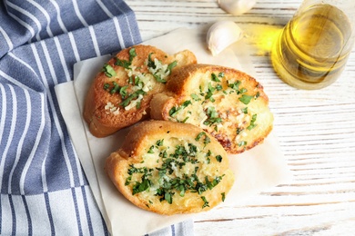 Flat lay composition with slices of garlic bread on table