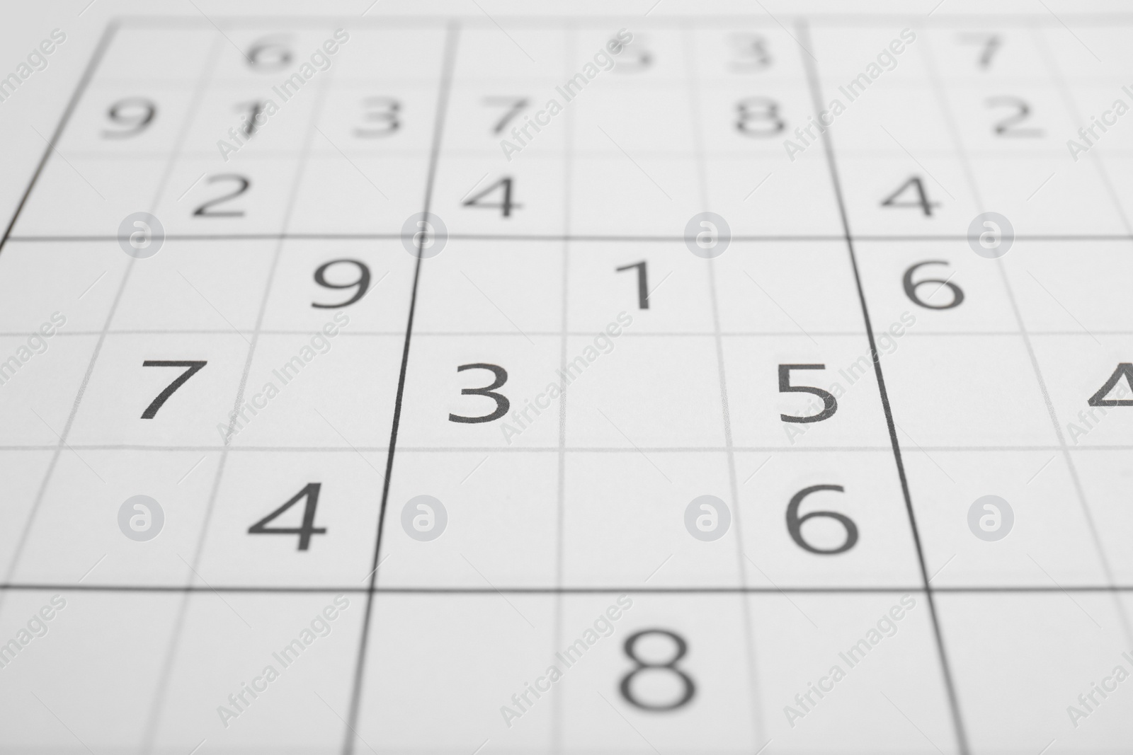 Photo of Sudoku puzzle grid as background, closeup view