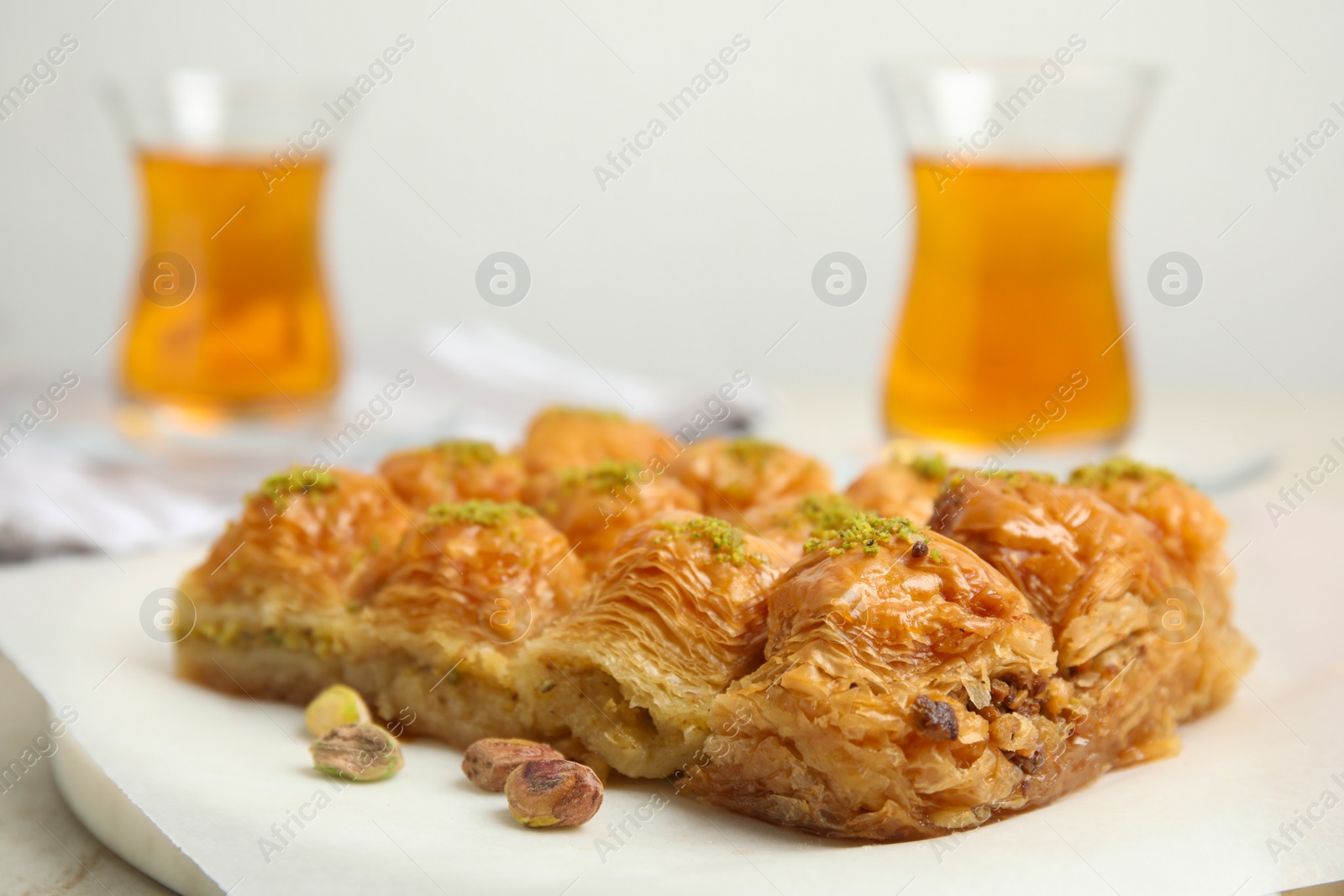 Photo of Delicious sweet baklava with pistachios on table, closeup