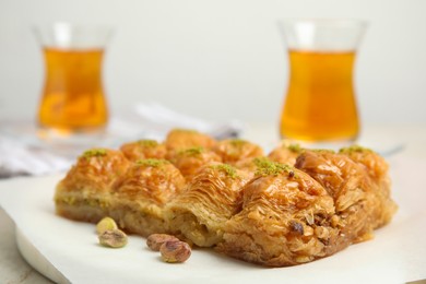 Photo of Delicious sweet baklava with pistachios on table, closeup