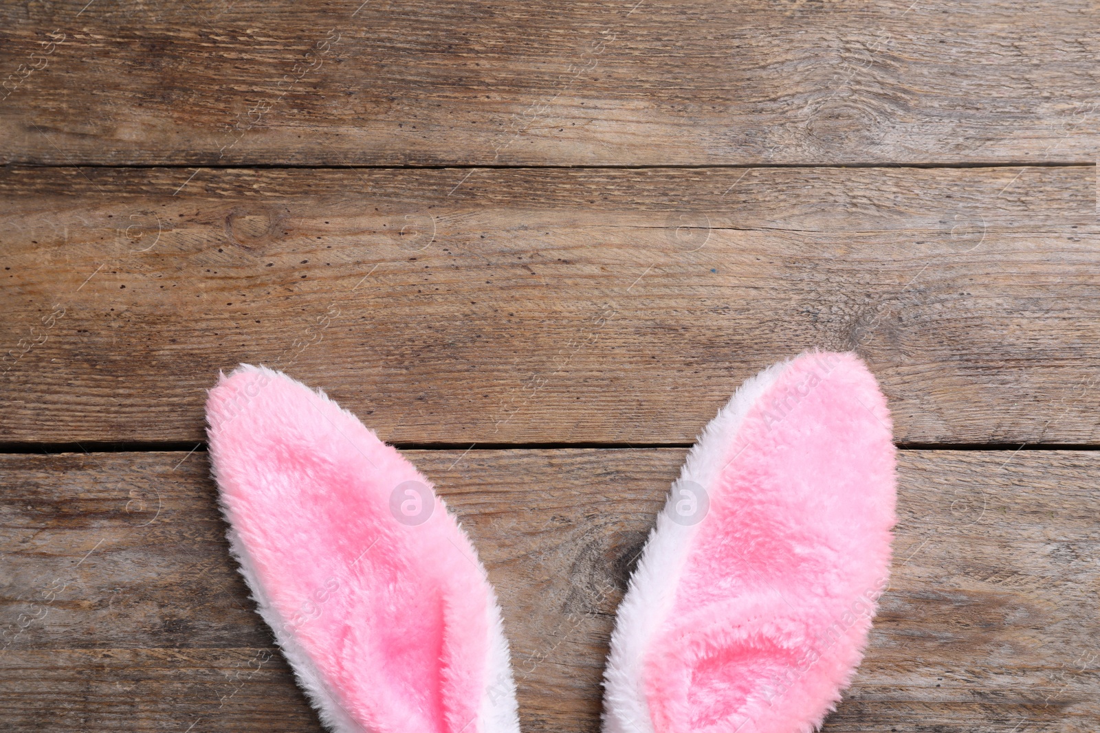 Photo of Decorative bunny ears and space for text on wooden background, flat lay. Easter holiday