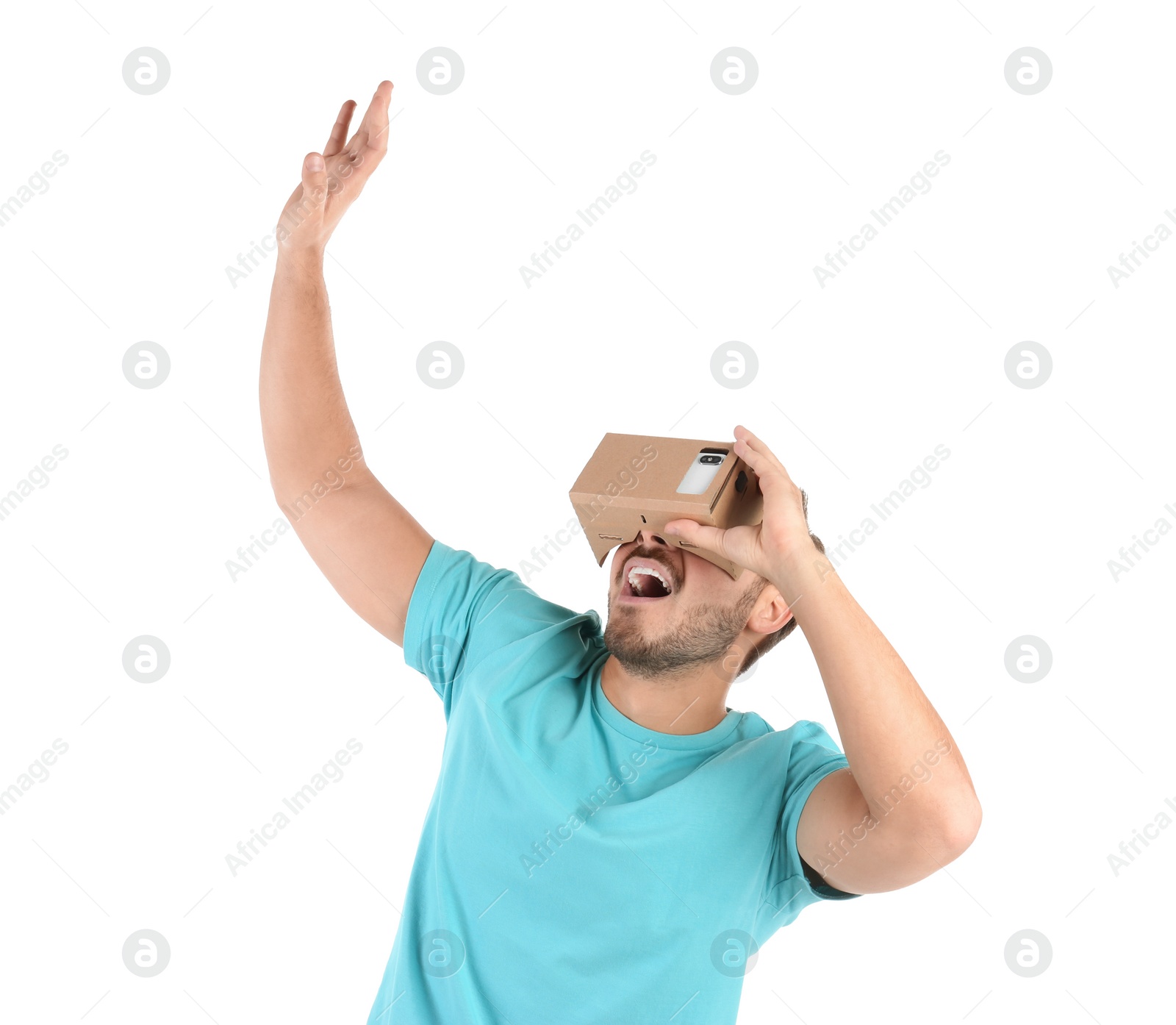 Photo of Young man using cardboard virtual reality headset, isolated on white