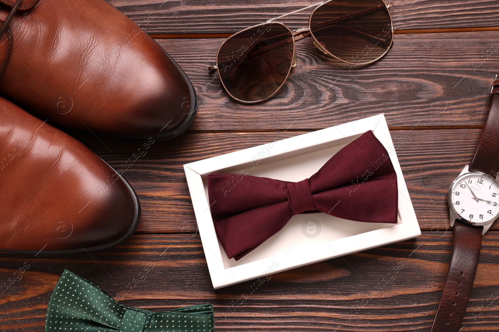 Photo of Flat lay composition with stylish color bow ties on wooden background