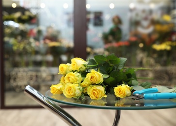 Photo of Beautiful bouquet on table in flower shop. Florist's workplace